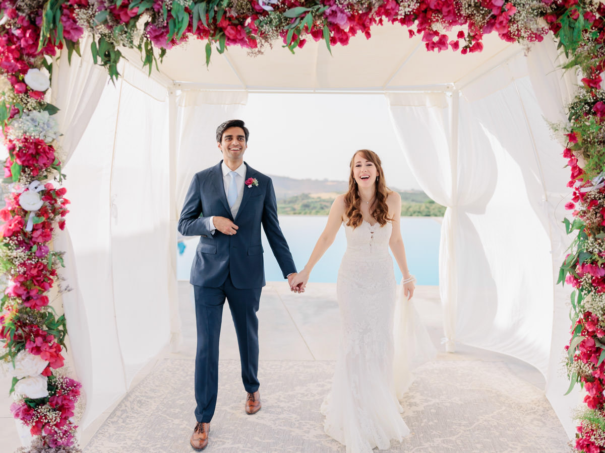 happy couple under a colorful arch