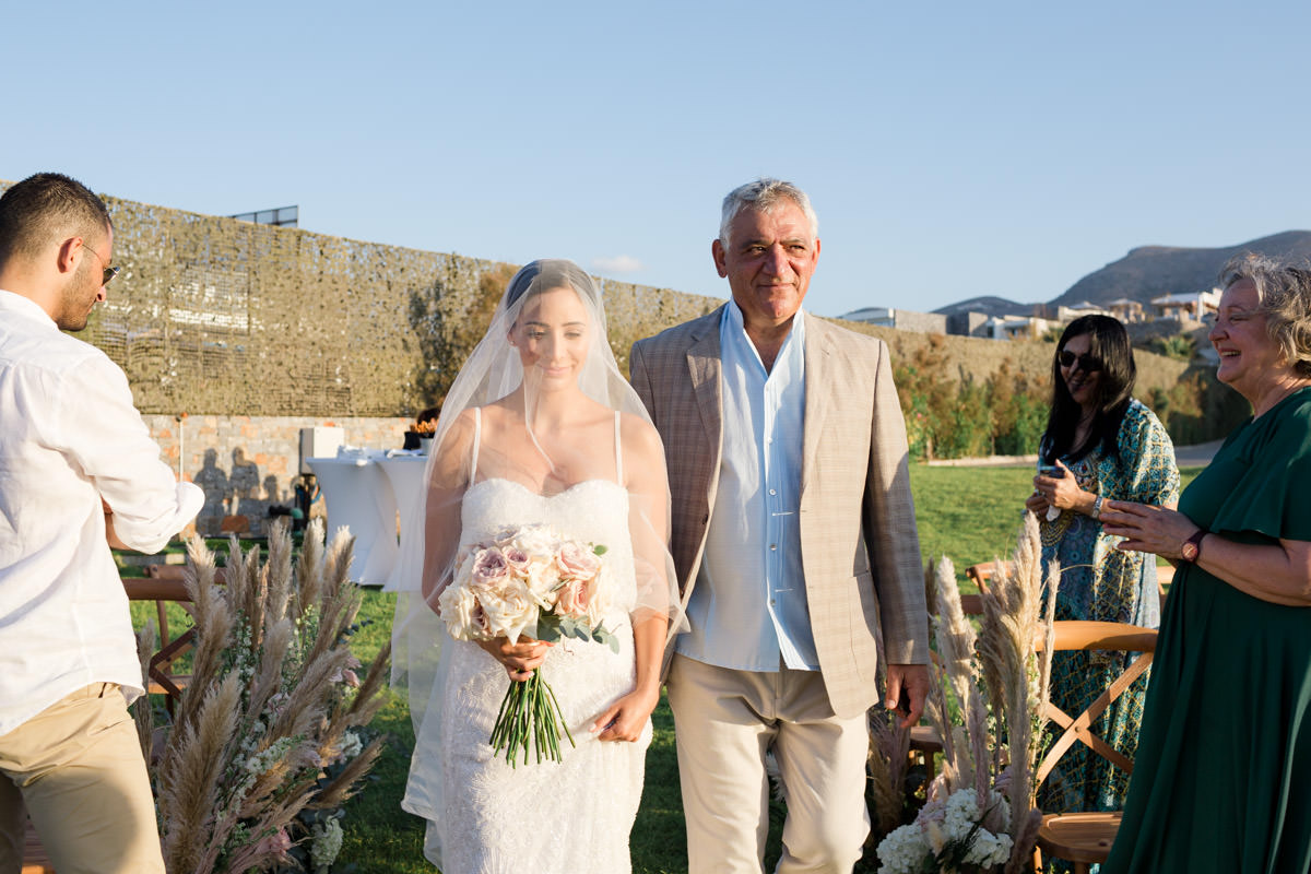 bride walking down the aisle with her father