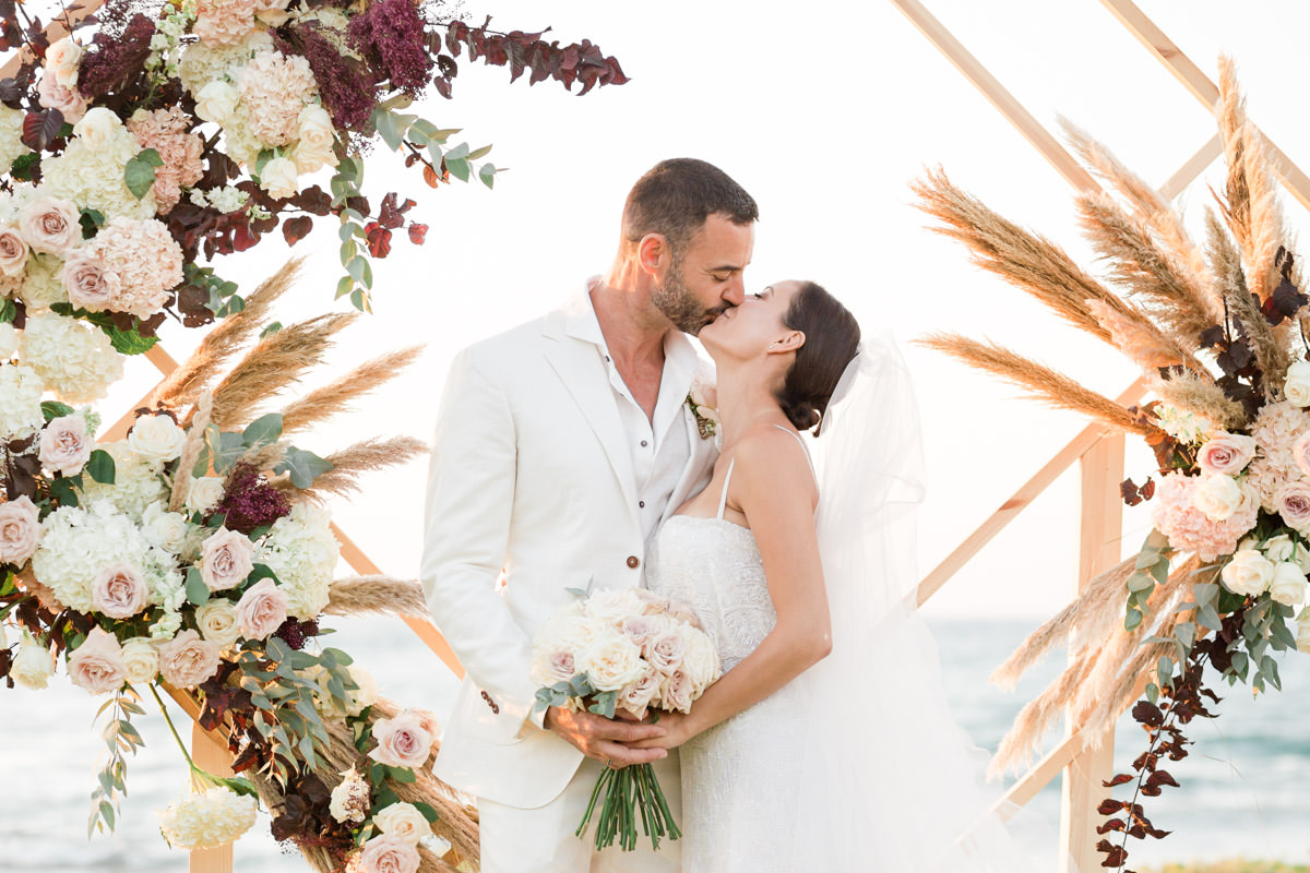 the groom kisses the bride