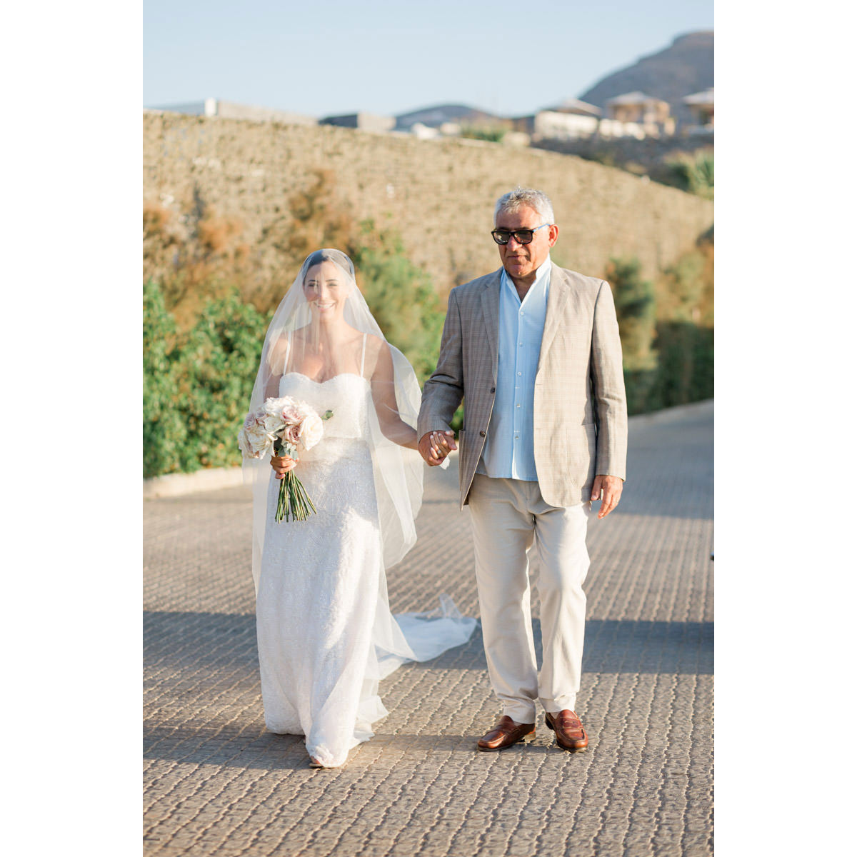 bride and her father walking together