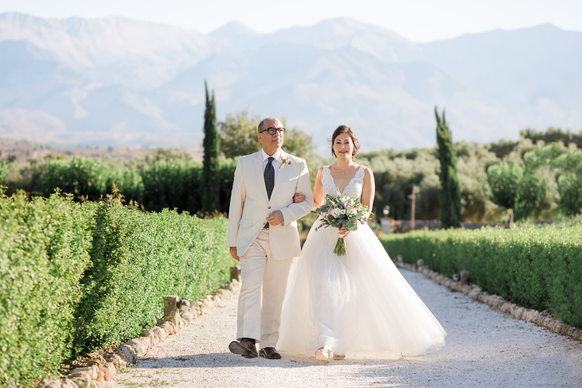 Iranian bride walking down the aisle with her father