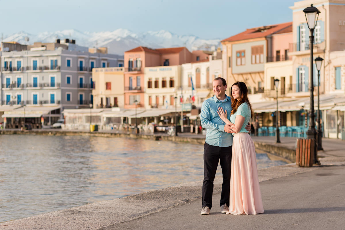 enjoying the sunrise in the old harbor in a colourful pallete and the white mountains of Crete in the background