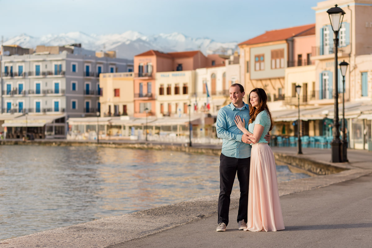 enjoying the sunrise in the old harbor in a colourful pallete and the white mountains of Crete in the background