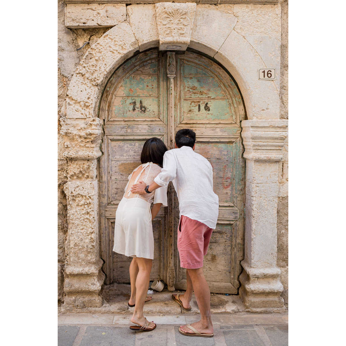 couple looks inside an old building in Rethymnon old town