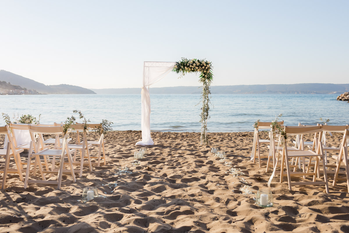 beach wedding and arch by the sea