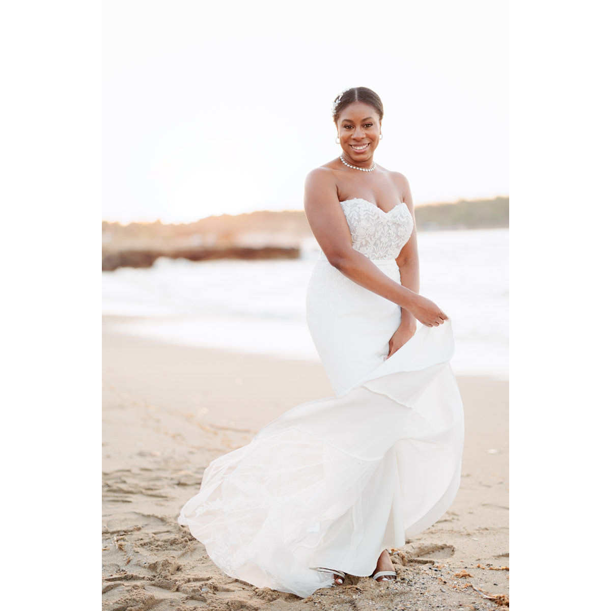 happy bride plays with her wedding dress