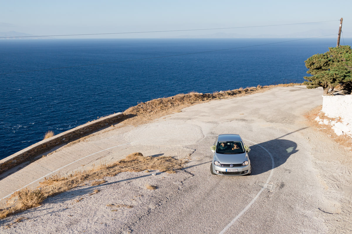 the guests arrive in the ceremony area on the top of a hill in a Greek island