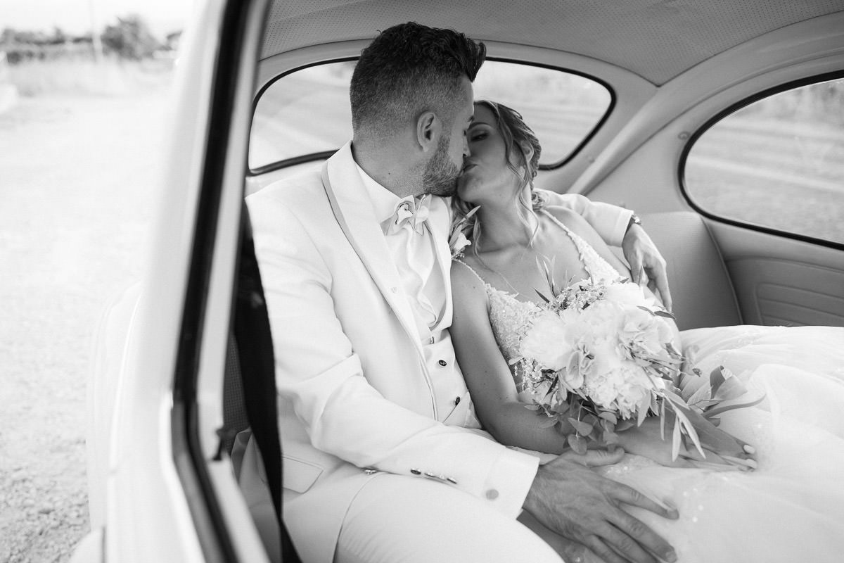 kissing in the wedding car