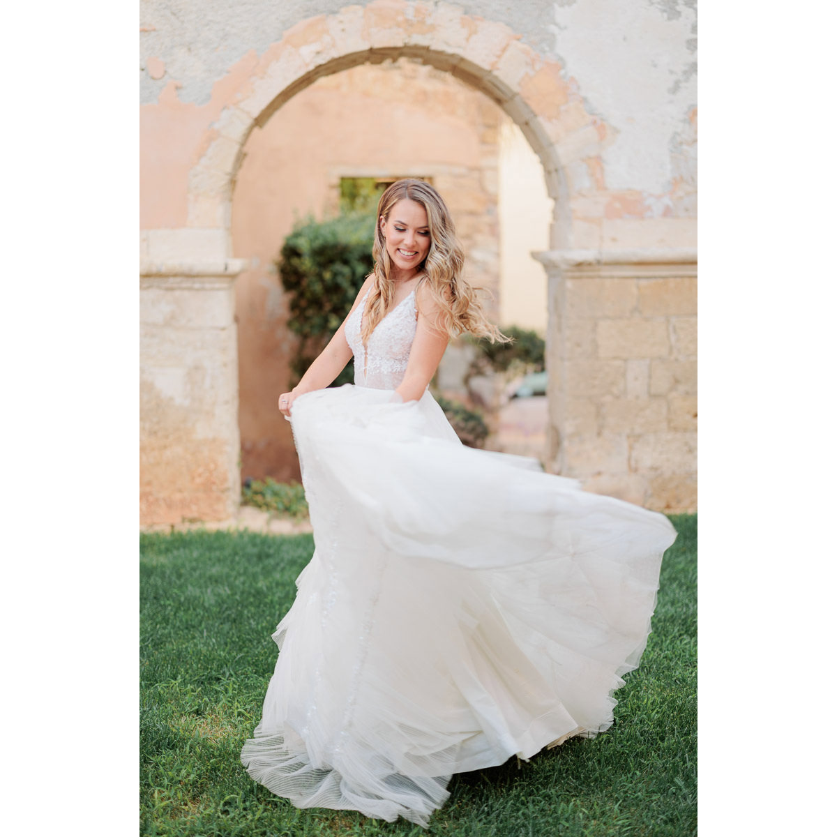 happy bride playing with her dress