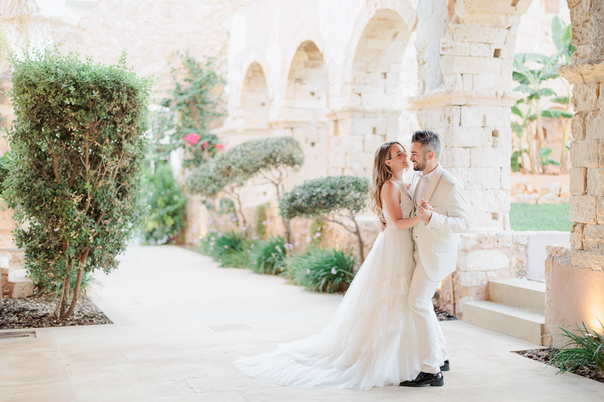 newly weds dancing among the old buildings