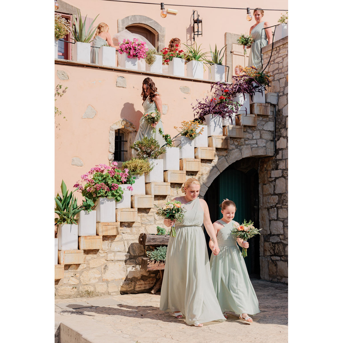 the bridesmaids walking down the stairs of Agreco