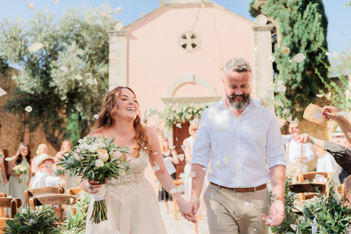 guests throw petals on the newlyweds in Agreco